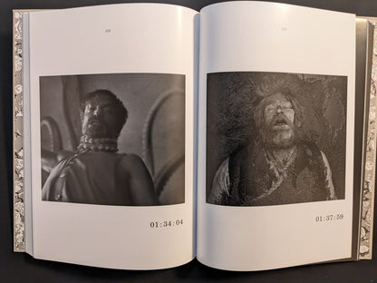 Double-page spread from The Lighthouse Screenplay Book featuring black-and-white stills of Robert Pattinson and Willem Dafoe.