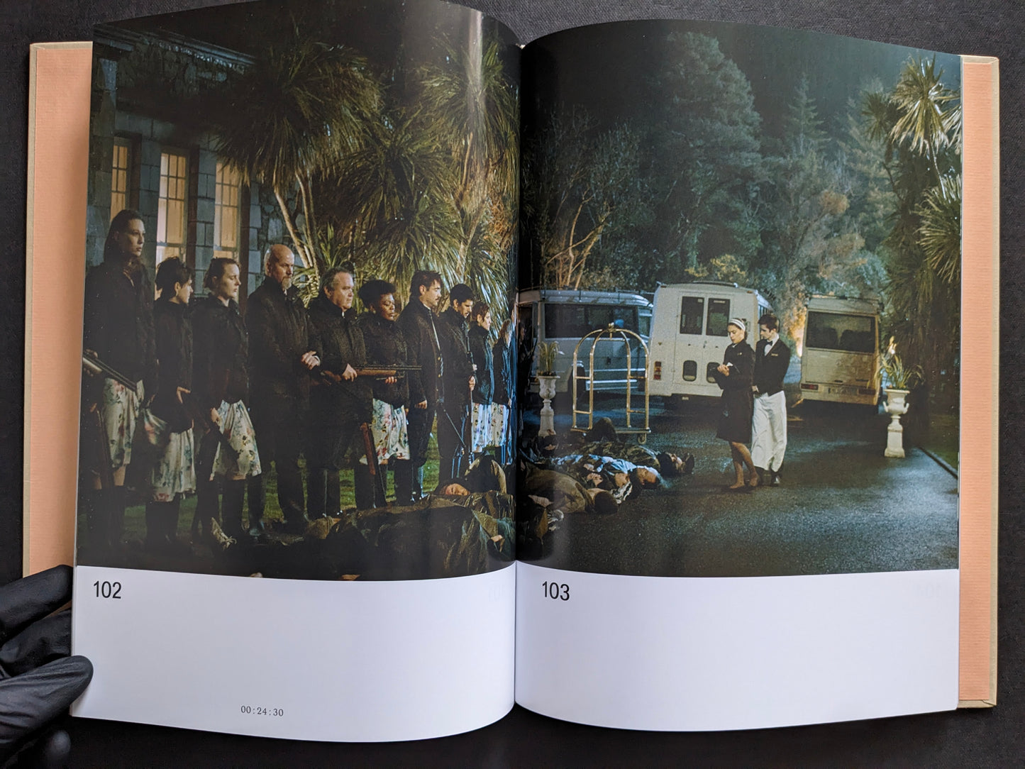 Interior spread with a film still from The Lobster showing hotel guests lined up outdoors at night beside bodies on the ground.