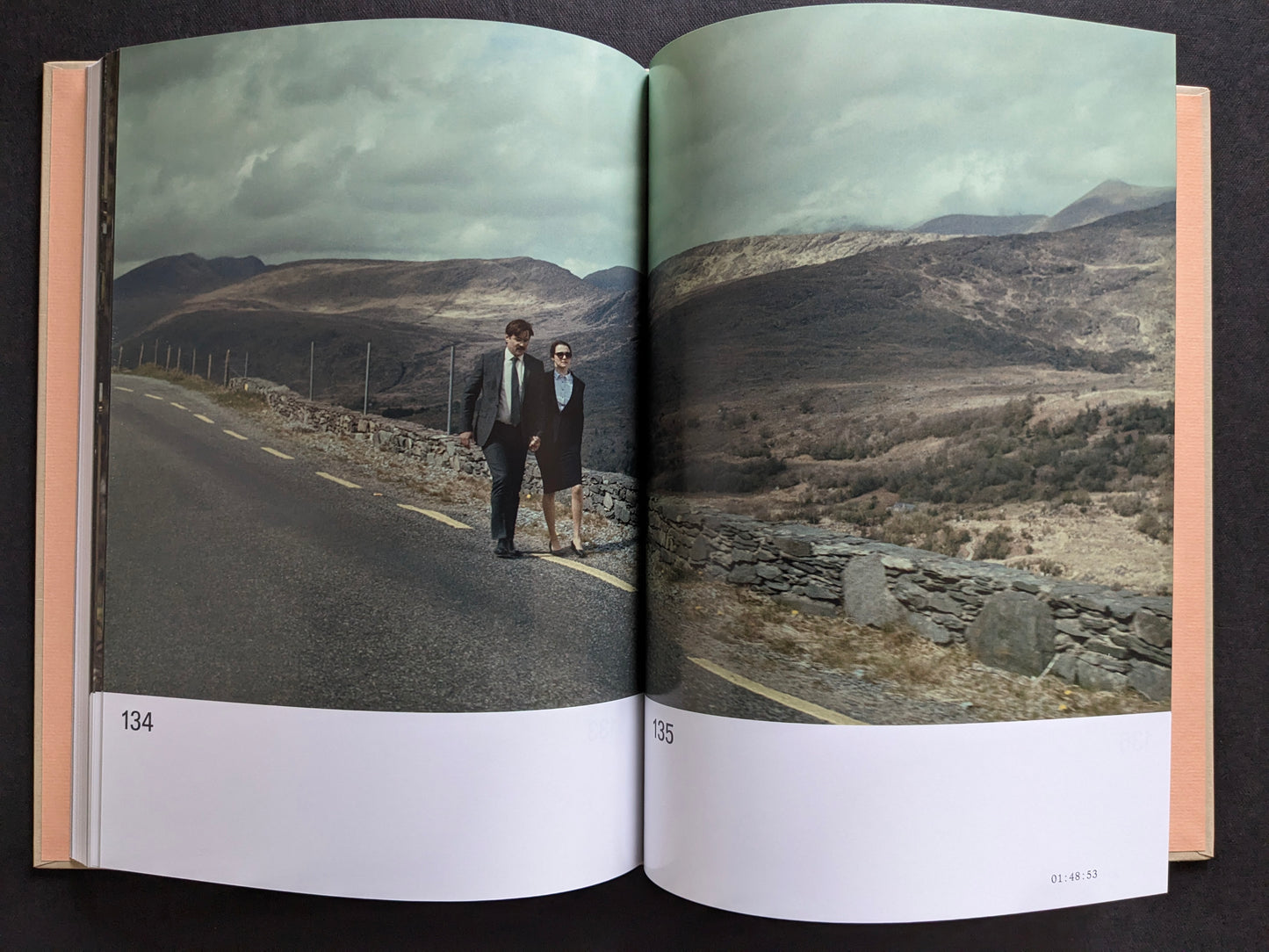 Interior spread with a film still from The Lobster showing David and the short-sighted woman walking along a roadside landscape.