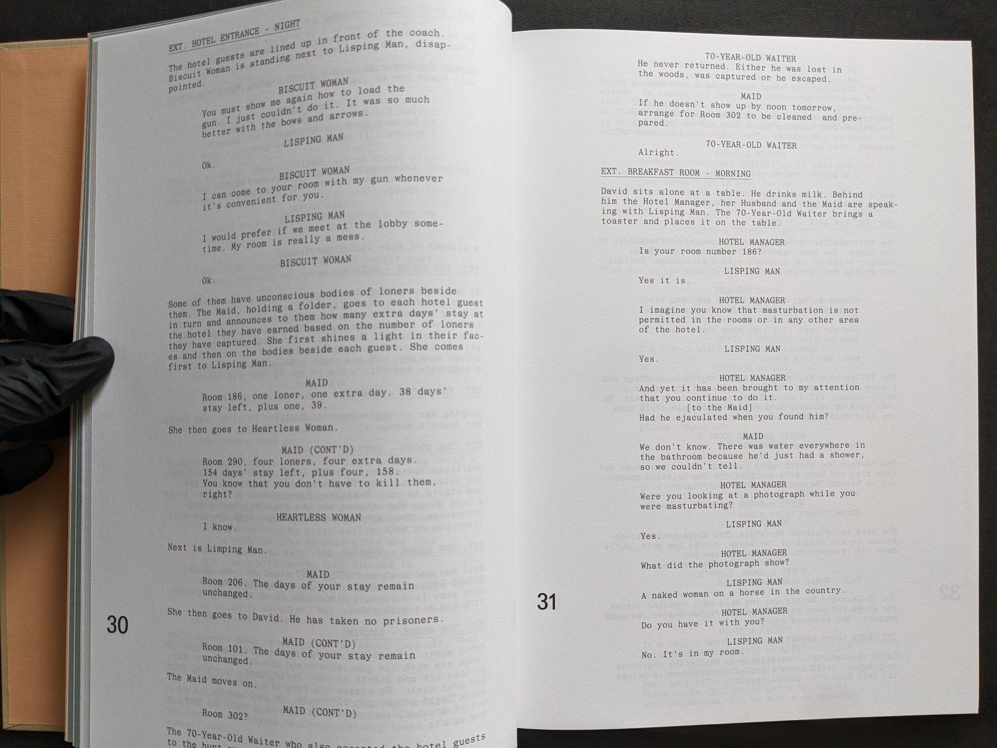 Interior screenplay spread from The Lobster featuring dialogue scenes set at the hotel entrance and breakfast room.