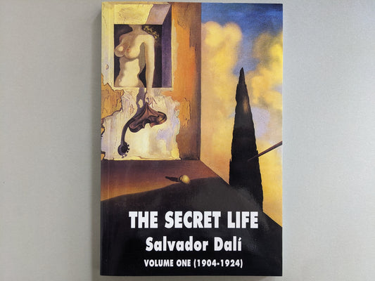 Front cover of "The Secret Life: Volume One (1904–1924)" by Salvador Dalí, featuring surrealist artwork with a window, a nude torso, and a distorted instrument-like form.