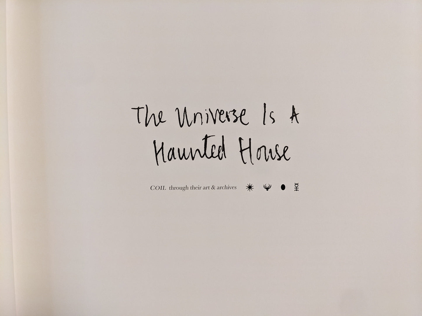 Title page of The Universe is a Haunted House showing handwritten title and COIL symbols.