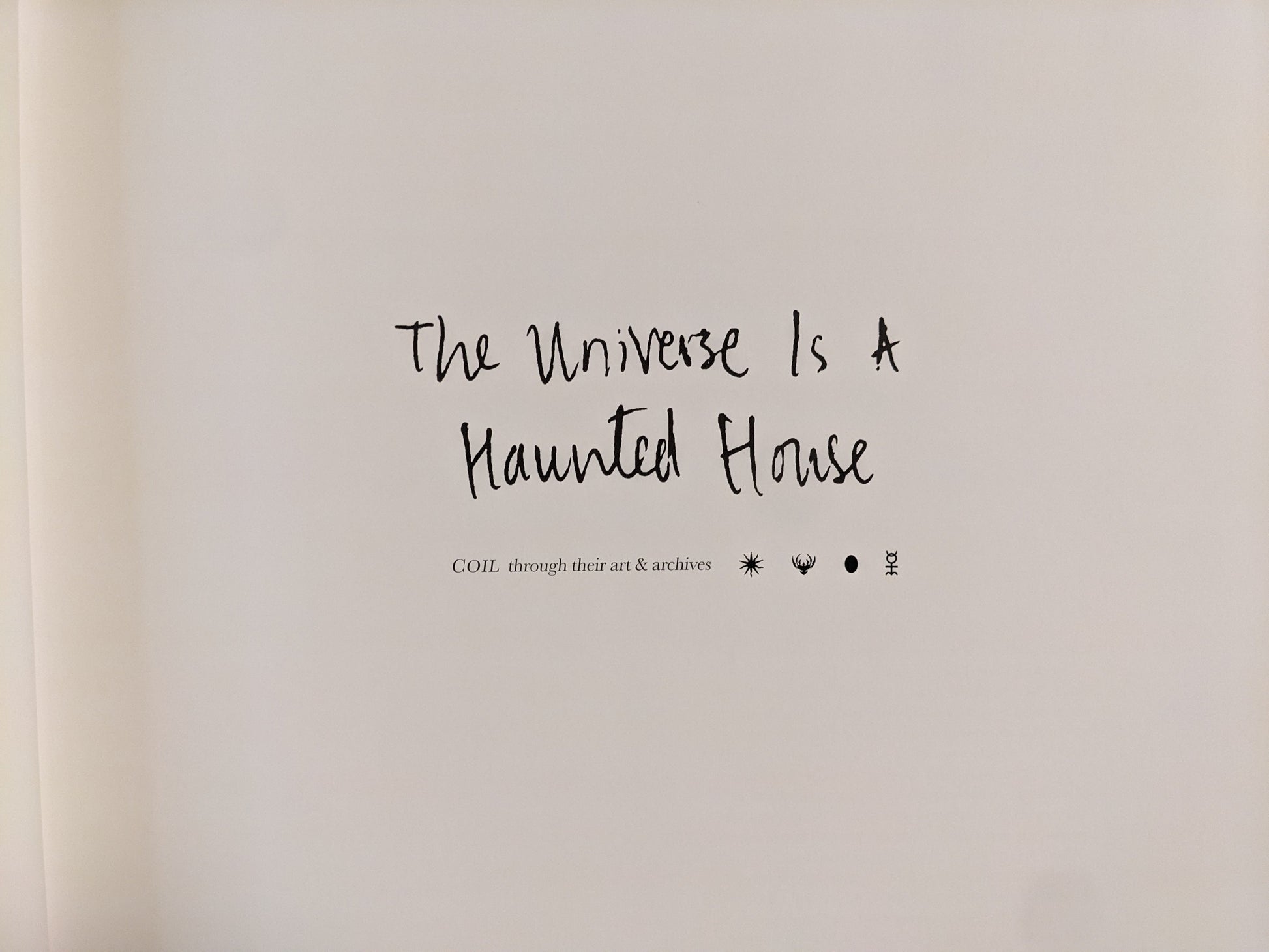 Title page of The Universe is a Haunted House showing handwritten title and COIL symbols.
