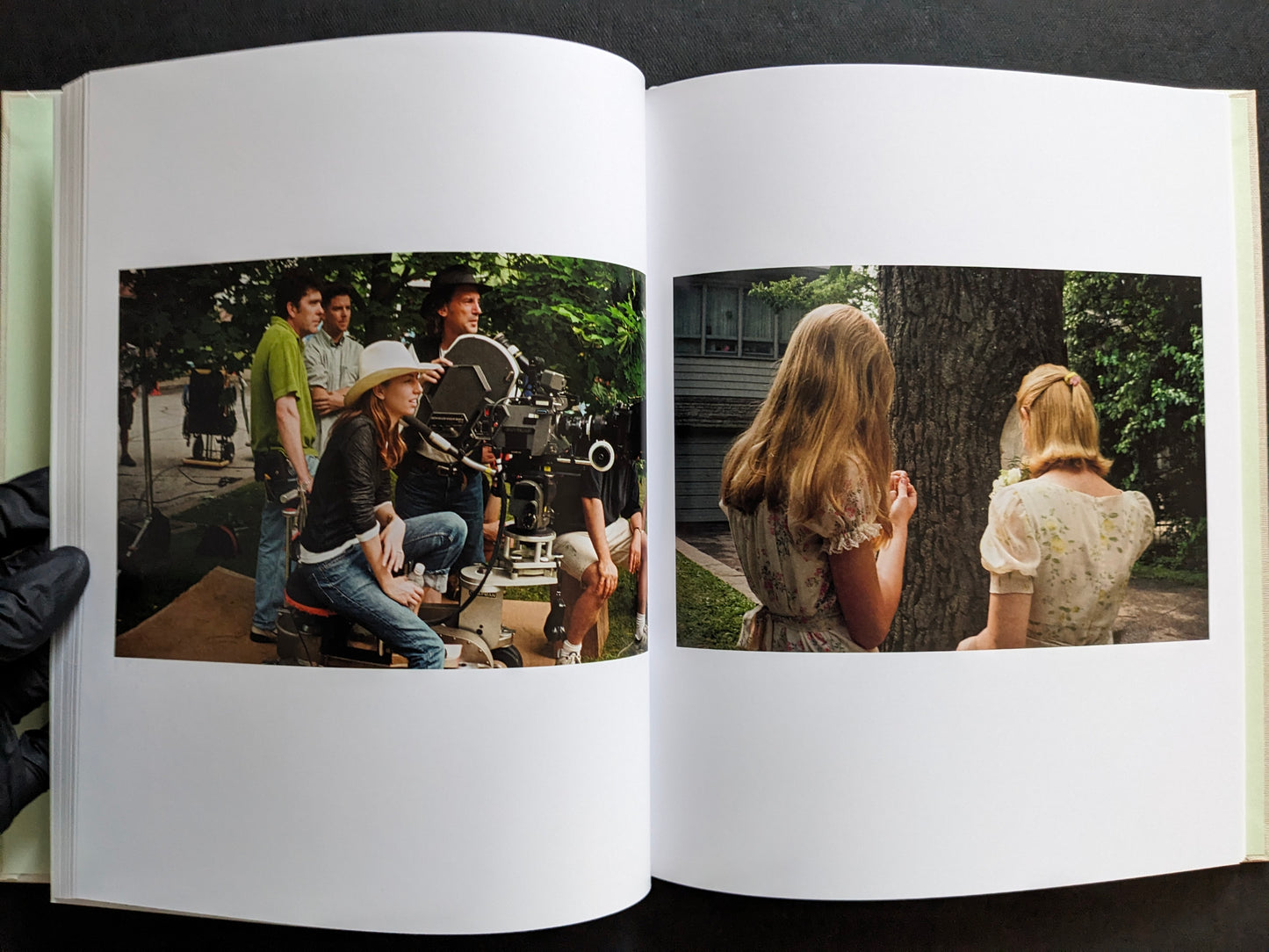 Interior spread from The Virgin Suicides book showing Sofia Coppola on set and two girls standing outdoors near a tree.