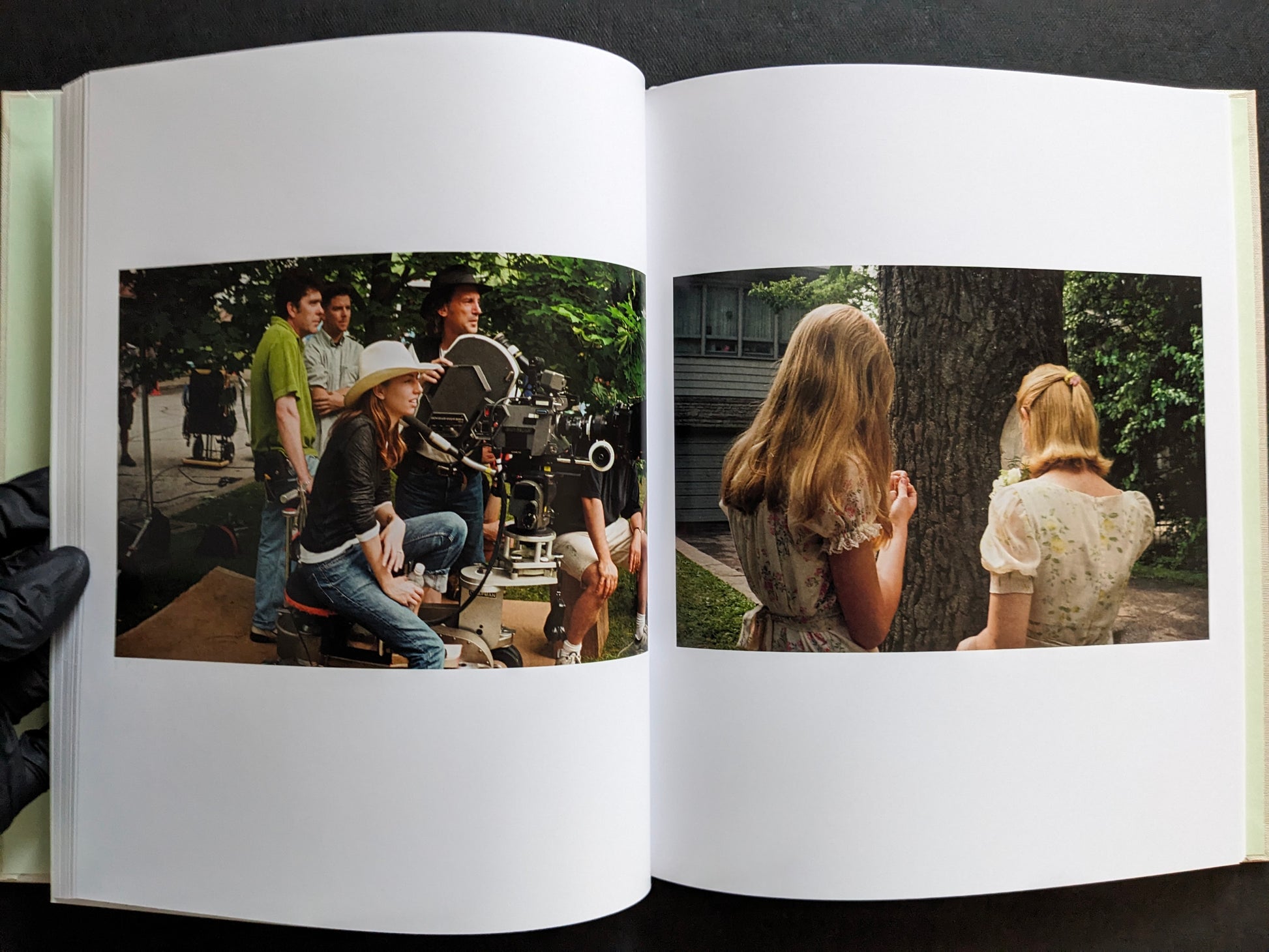 Interior spread from The Virgin Suicides book showing Sofia Coppola on set and two girls standing outdoors near a tree.