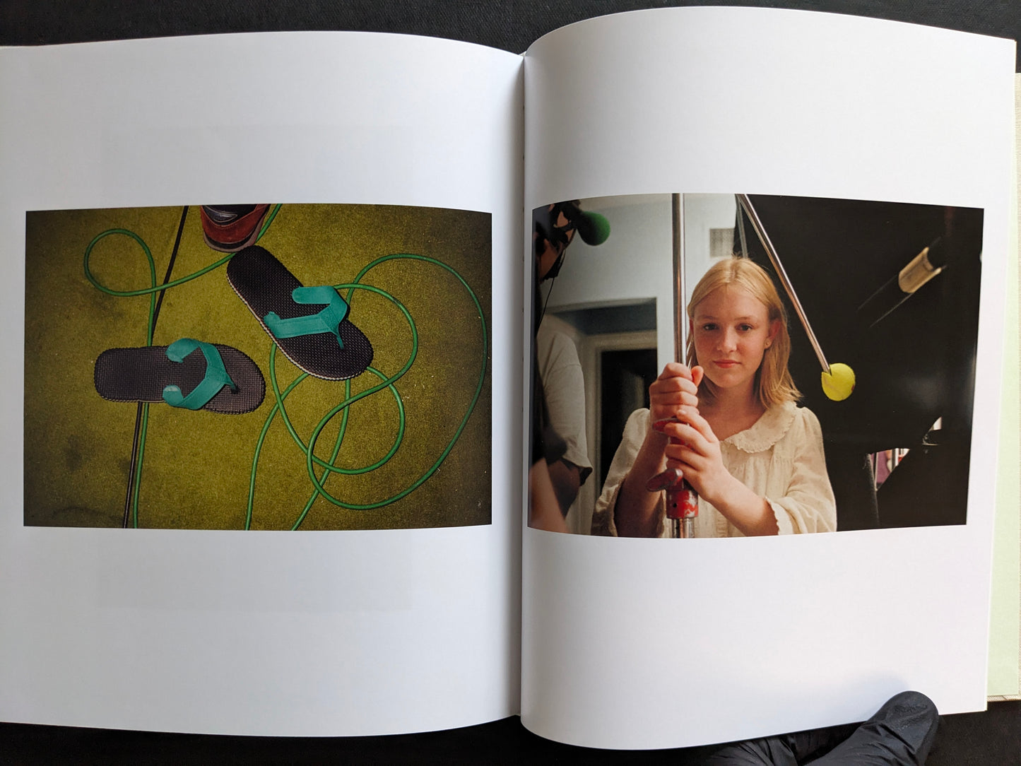 Interior spread from The Virgin Suicides book showing a still life of flip-flops and a behind-the-scenes portrait of a young actress holding film equipment.