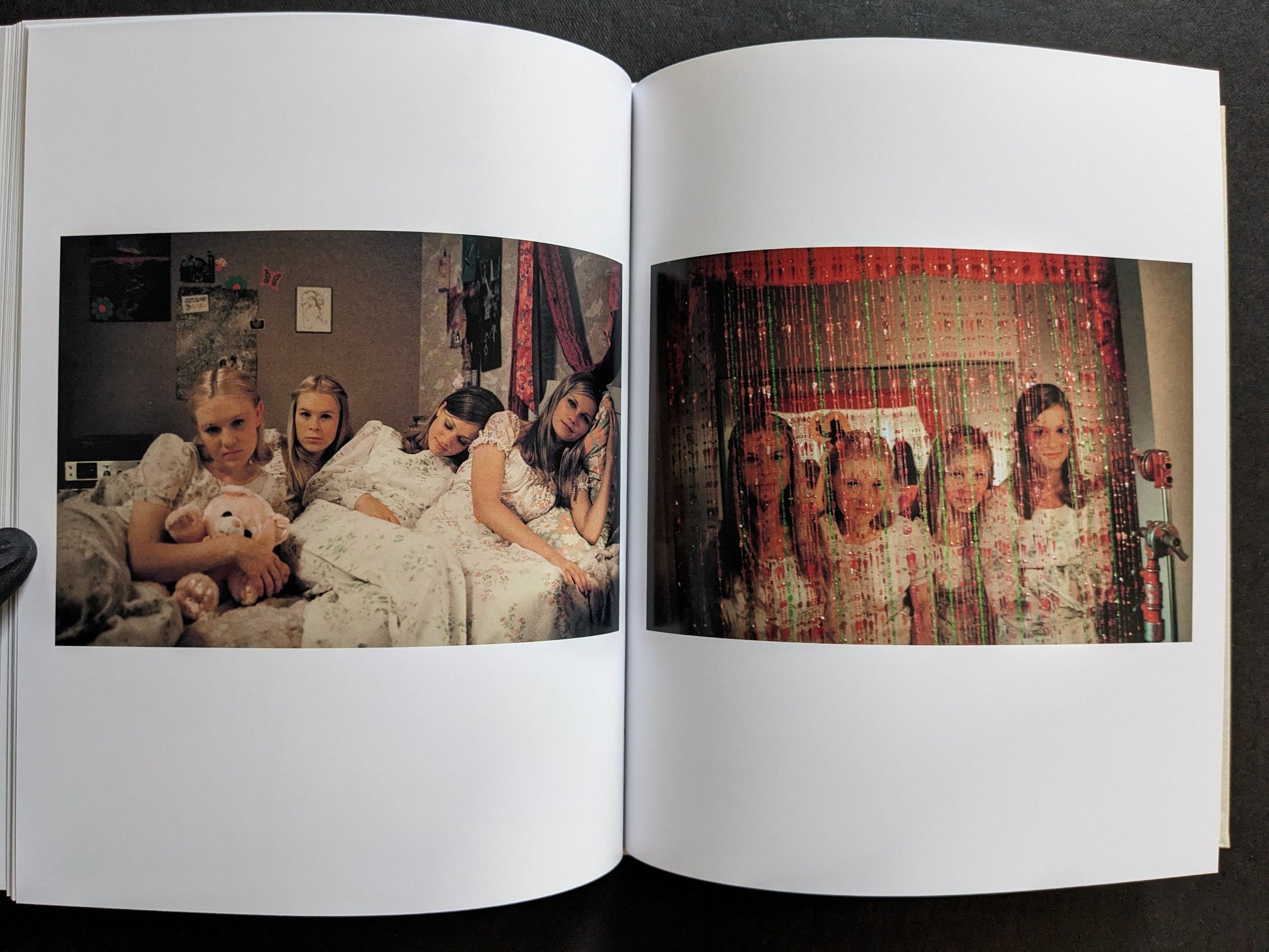 Interior spread from The Virgin Suicides book showing the Lisbon sisters together in a bedroom in two different images.