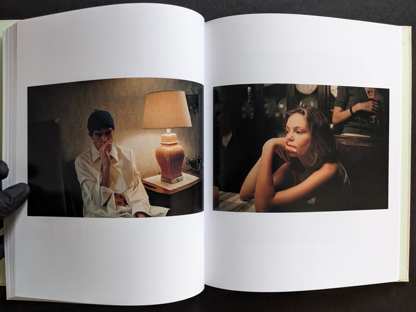 Interior spread with two character portraits in softly lit interior scenes.