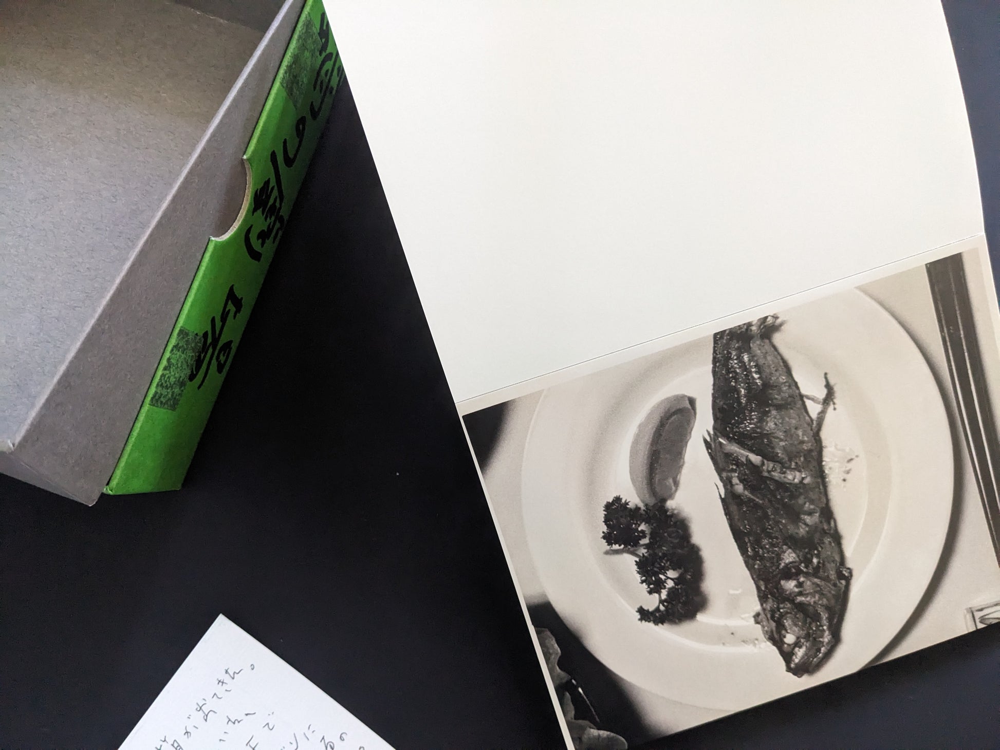 Black-and-white photograph of a grilled fish served on a plate from 'Theater of Love' by Nobuyoshi Araki