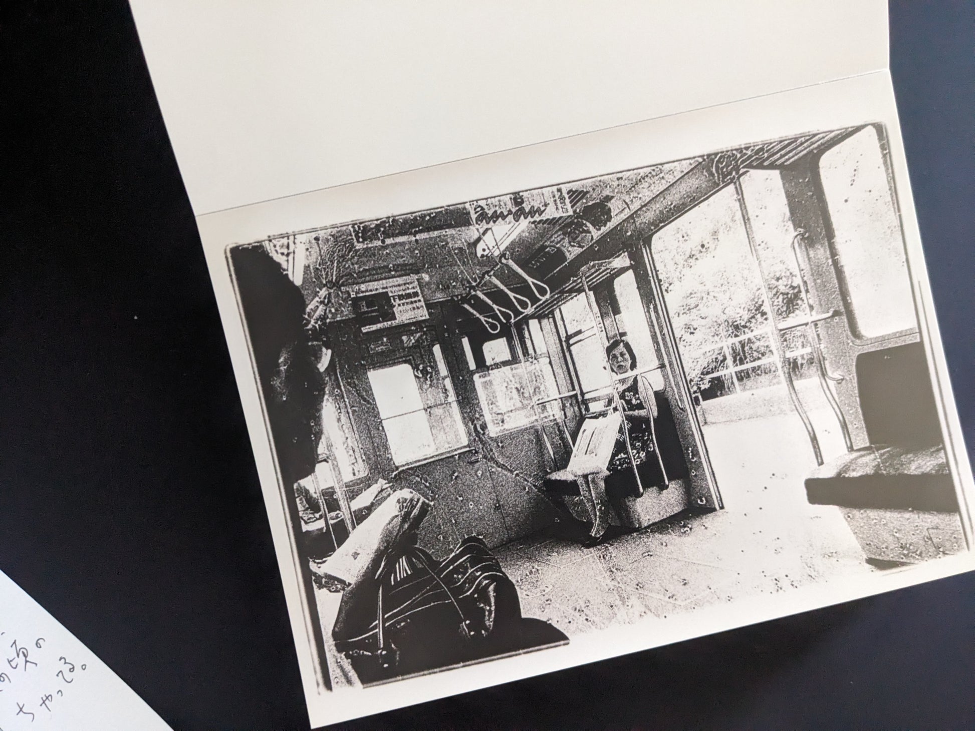 Grainy black-and-white print of passengers inside a train car
