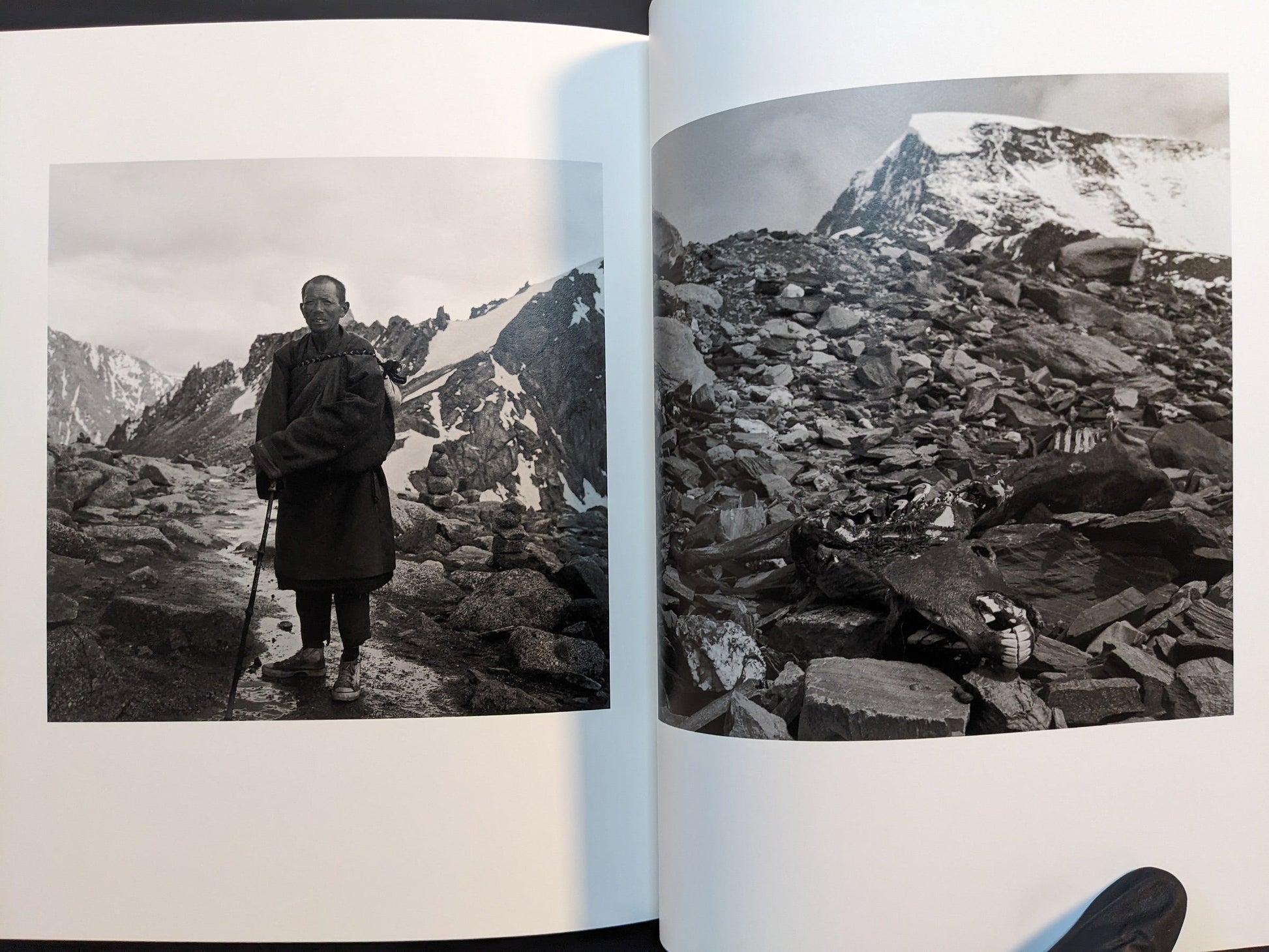 Spread from Tibet with an animal skull among rocks and a portrait in a rocky mountain landscape.