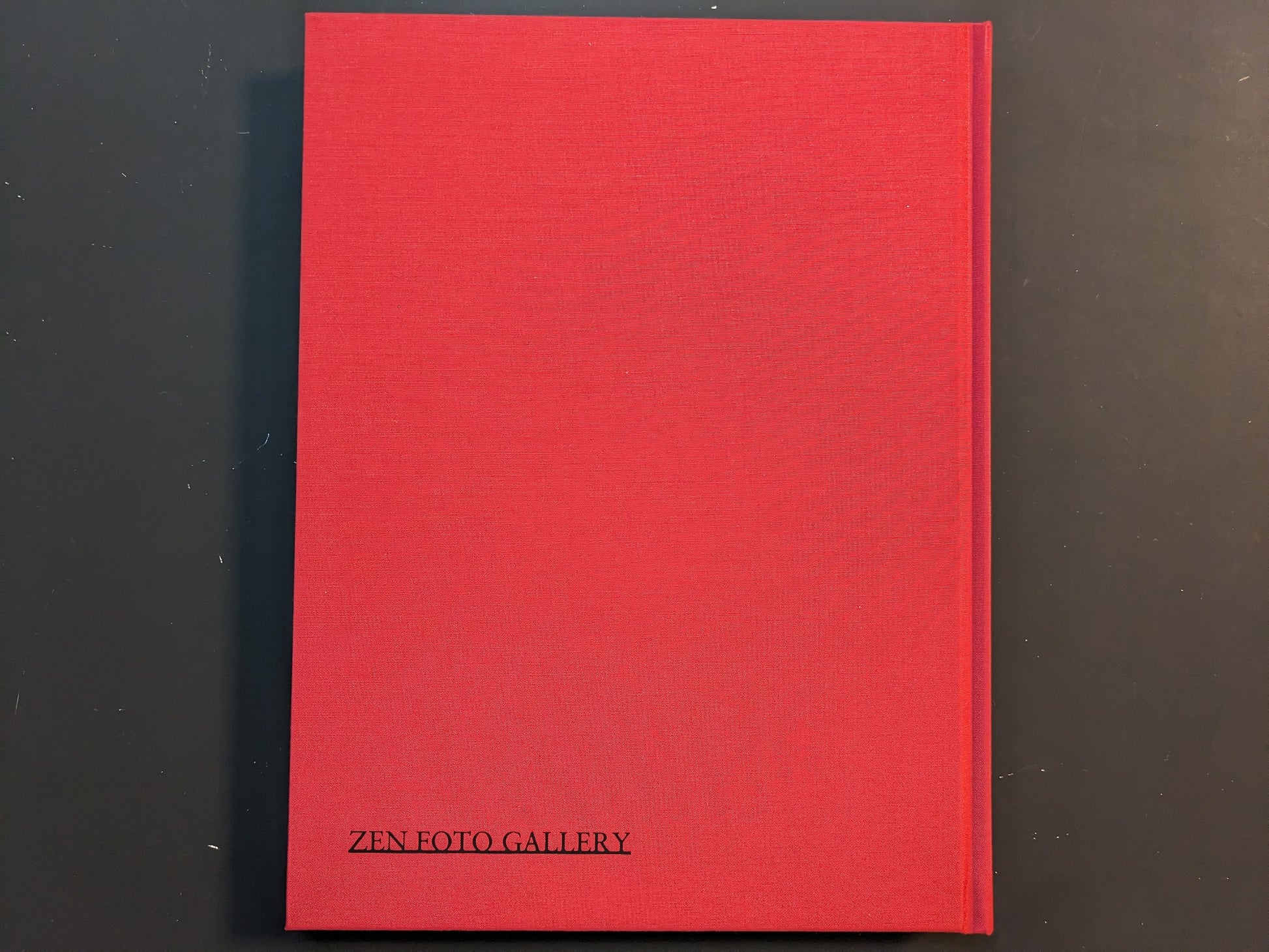 Back view of the red cloth hardcover of “TIBET” by Shinya Arimoto with the Zen Foto Gallery imprint at the bottom.
