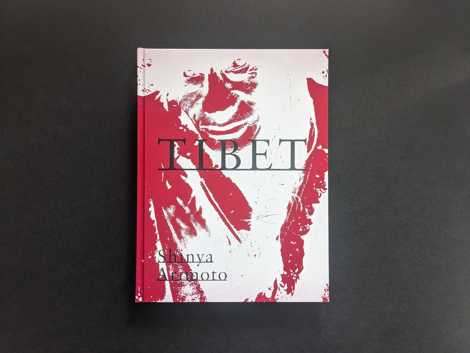 Cover of Tibet by Shinya Arimoto, with a red-and-white portrait design and the title across the centre.