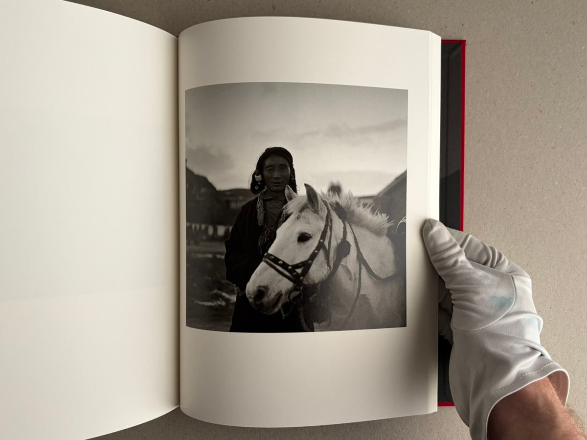 Open photobook spread with two black-and-white portraits, Tibet – Shinya Arimoto