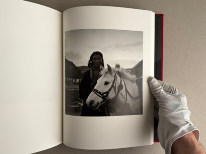 Open photobook spread with two black-and-white portraits, Tibet – Shinya Arimoto