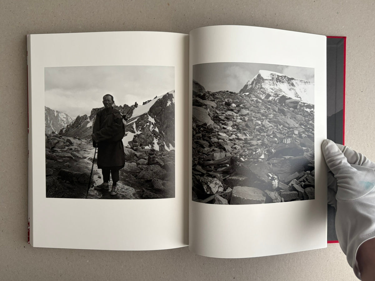 Open photobook spread with a black-and-white portrait and a mountain landscape, Tibet – Shinya Arimoto