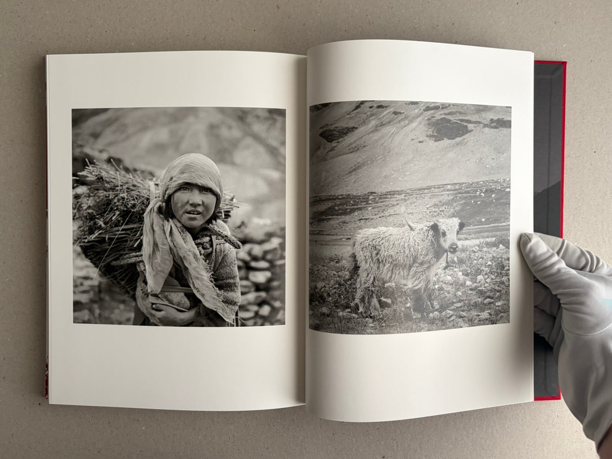 Open photobook spread with a black-and-white portrait and a mountain landscape, Tibet – Shinya Arimoto