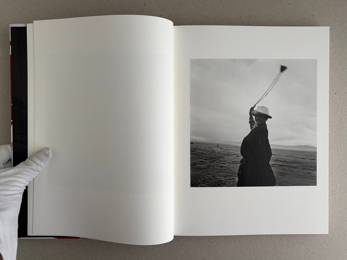 Open photobook spread with a black-and-white portrait on the right page, Tibet – Shinya Arimoto