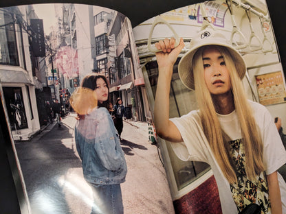 Spread from "Tokyo Girls" with a young woman walking down a Tokyo alley and another holding onto a subway handle.