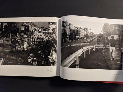 Open spread with a woman in a graffiti-covered alley and a quiet Tokyo street scene with a person walking away under an umbrella.