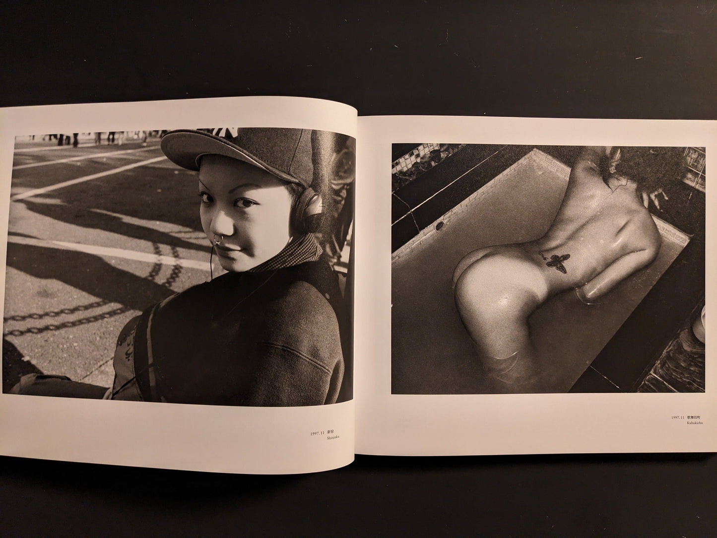 Open spread with a bare-backed figure with a butterfly tattoo and a young woman standing on a city street.