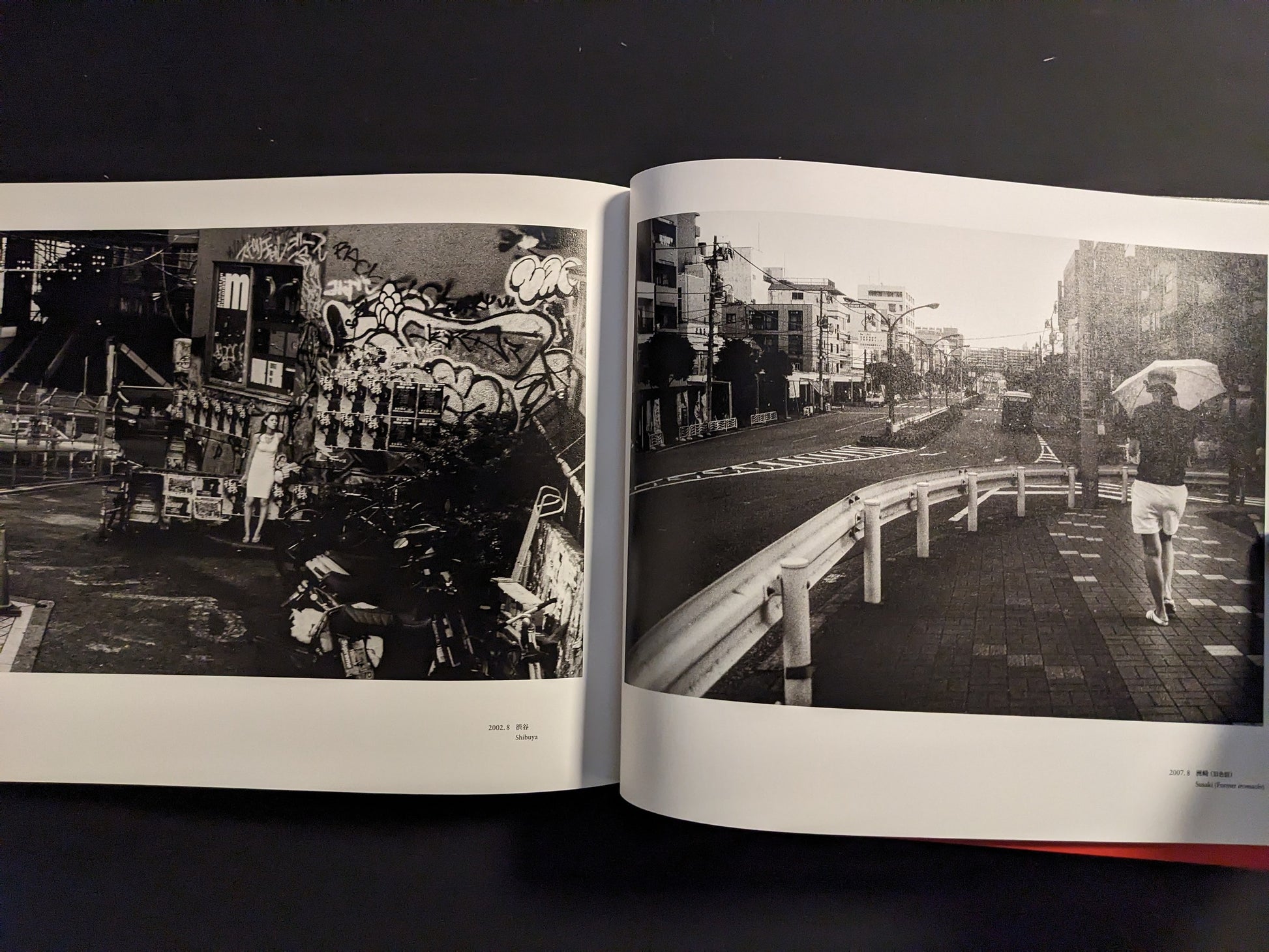 Spread from “Tokyo on the Brink of Sanity” featuring a woman in a cluttered graffiti-covered alley and a quiet Tokyo street scene with a person walking away holding an umbrella.