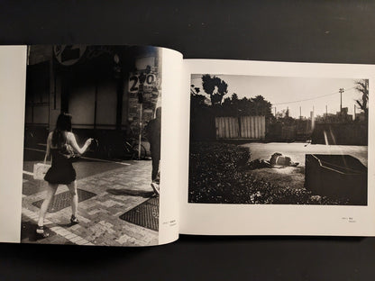 Spread from “Tokyo on the Brink of Sanity” with a sunlit open space and a distant figure, paired with a woman walking along a tiled Tokyo sidewalk.
