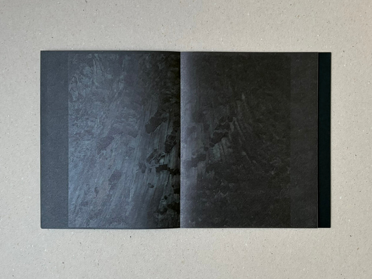 torikumo by Haruka Fujita, open accordion-bound photobook showing a dark two-page spread with layered abstract imagery