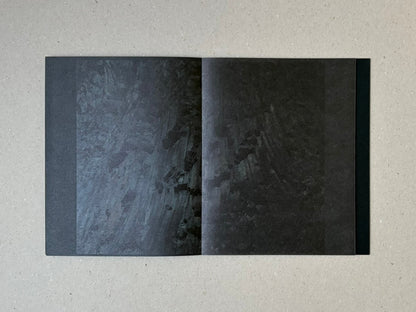 torikumo by Haruka Fujita, open accordion-bound photobook showing a dark two-page spread with layered abstract imagery