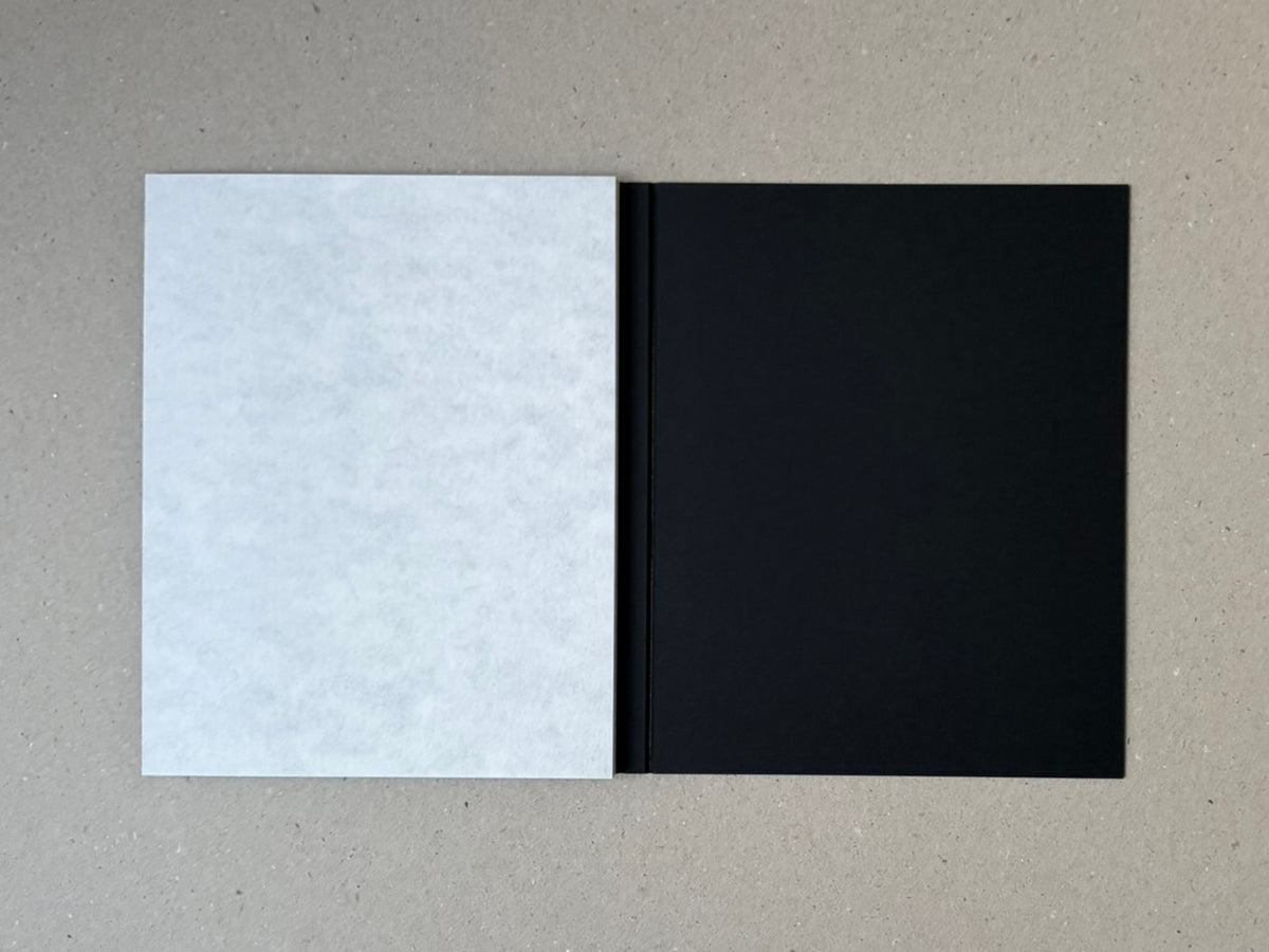 torikumo by Haruka Fujita, open accordion-bound photobook shown as a white page beside a black page