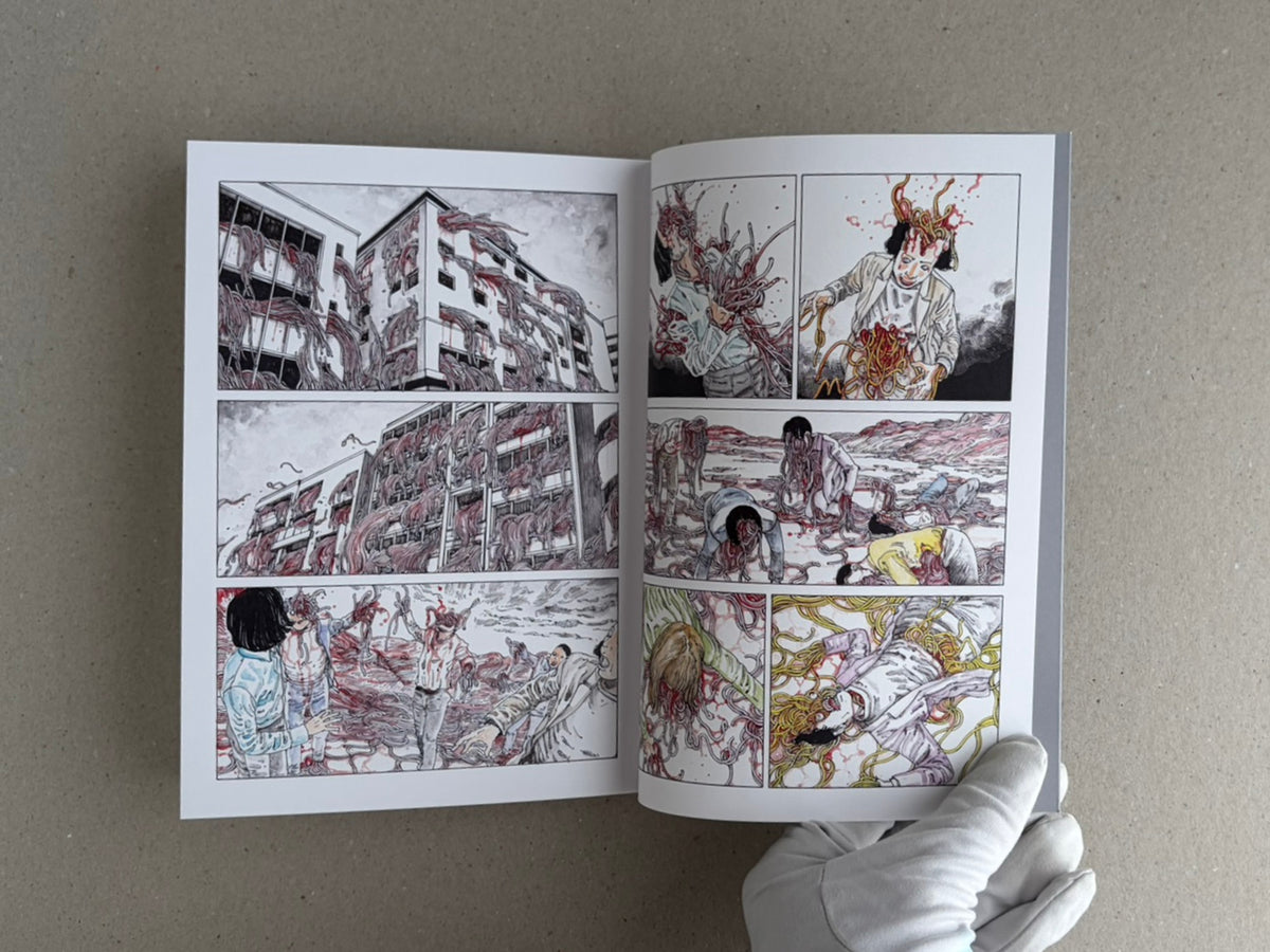 Open TRACT (pocket edition) by Shintaro Kago, showing a full-colour interior spread with multiple comic panels and a gloved hand holding the lower right corner.