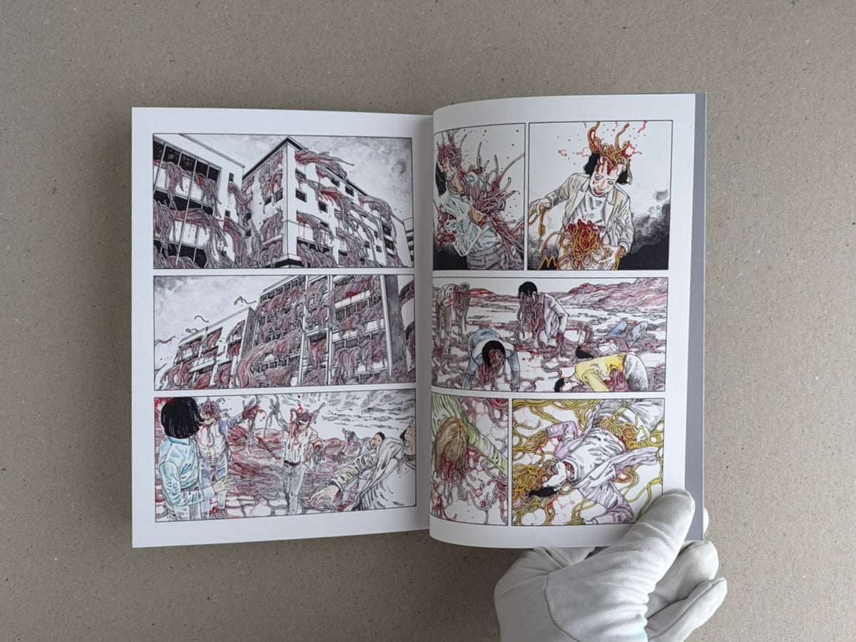 Open TRACT (pocket edition) by Shintaro Kago, showing a two-page interior comic spread with multiple panels and a gloved hand holding the book open.