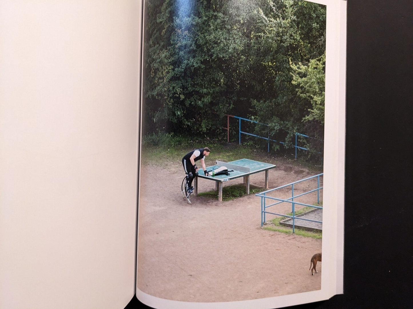 Photograph of a person resting near the table with a bicycle nearby.