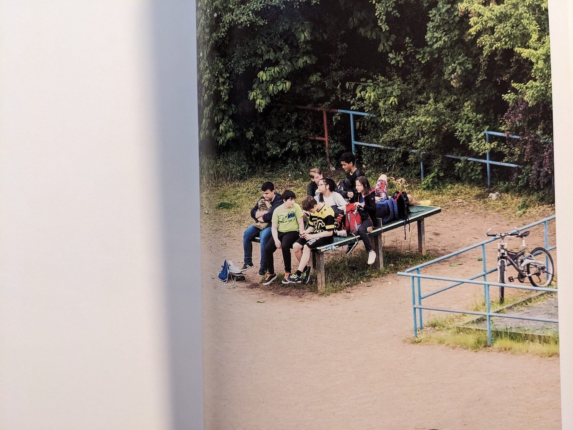 Photograph of a group of young people gathered and sitting around the table.