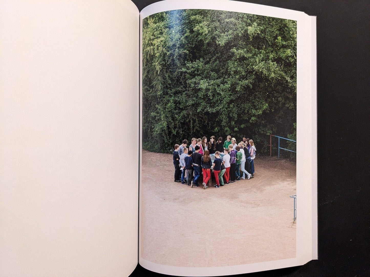 Photograph of a group of children gathered near the ping-pong table.