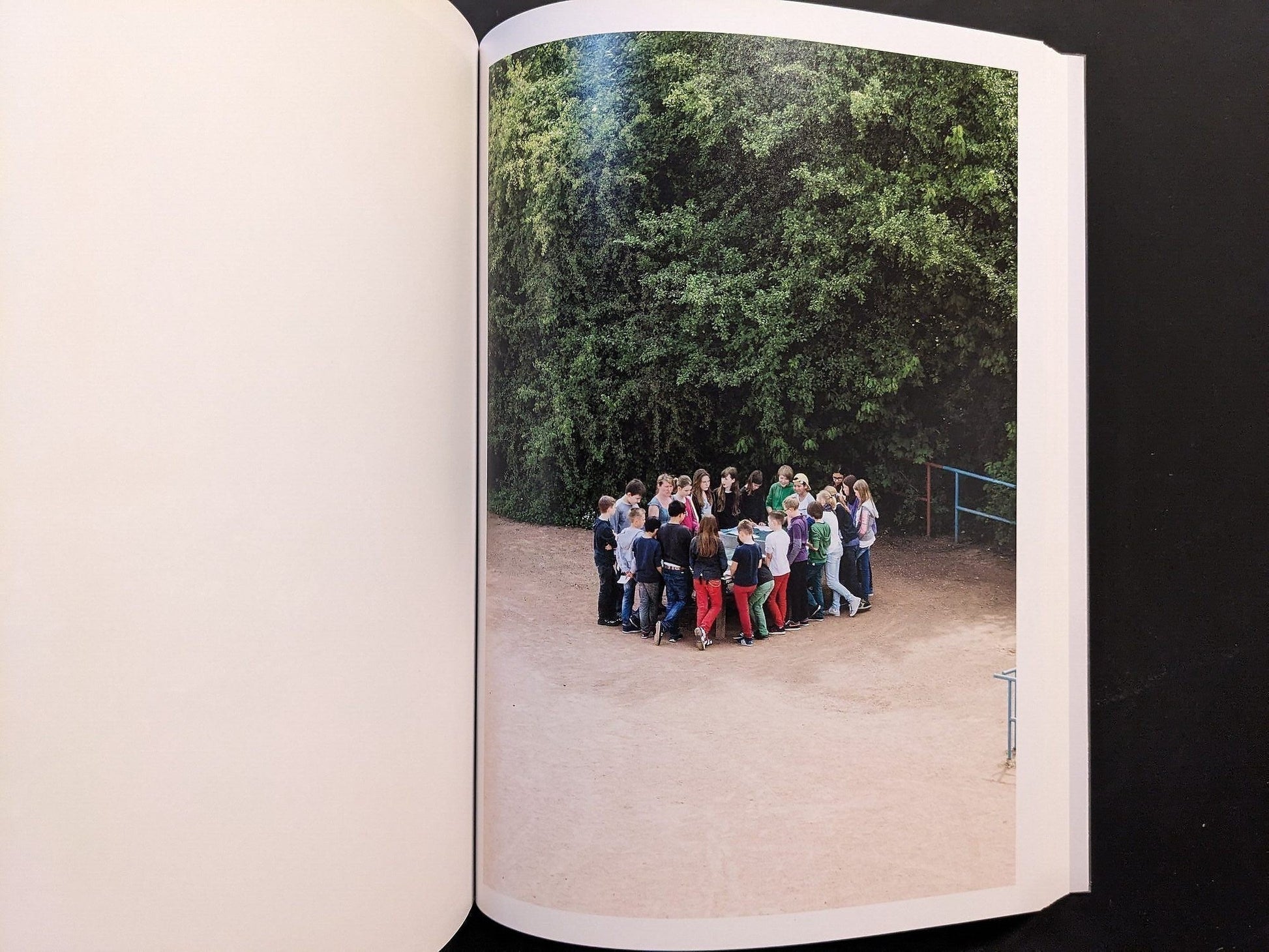 Photograph from TTP by Hayahisa Tomiyasu showing a group of children gathered near the ping pong table.