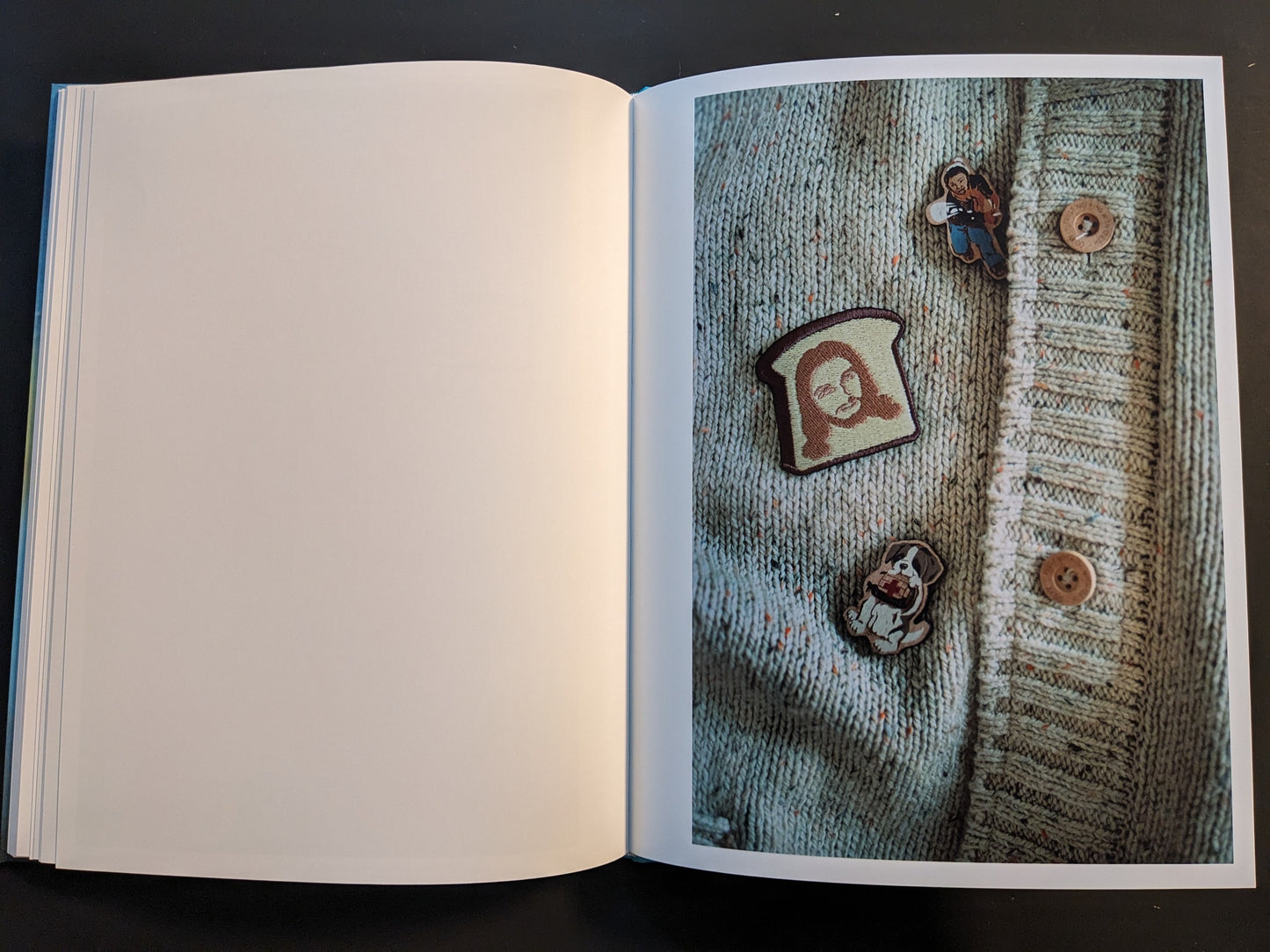 Open spread from ¥€$U$ (JESUS) showing a knitted cardigan decorated with Jesus-themed novelty badges.