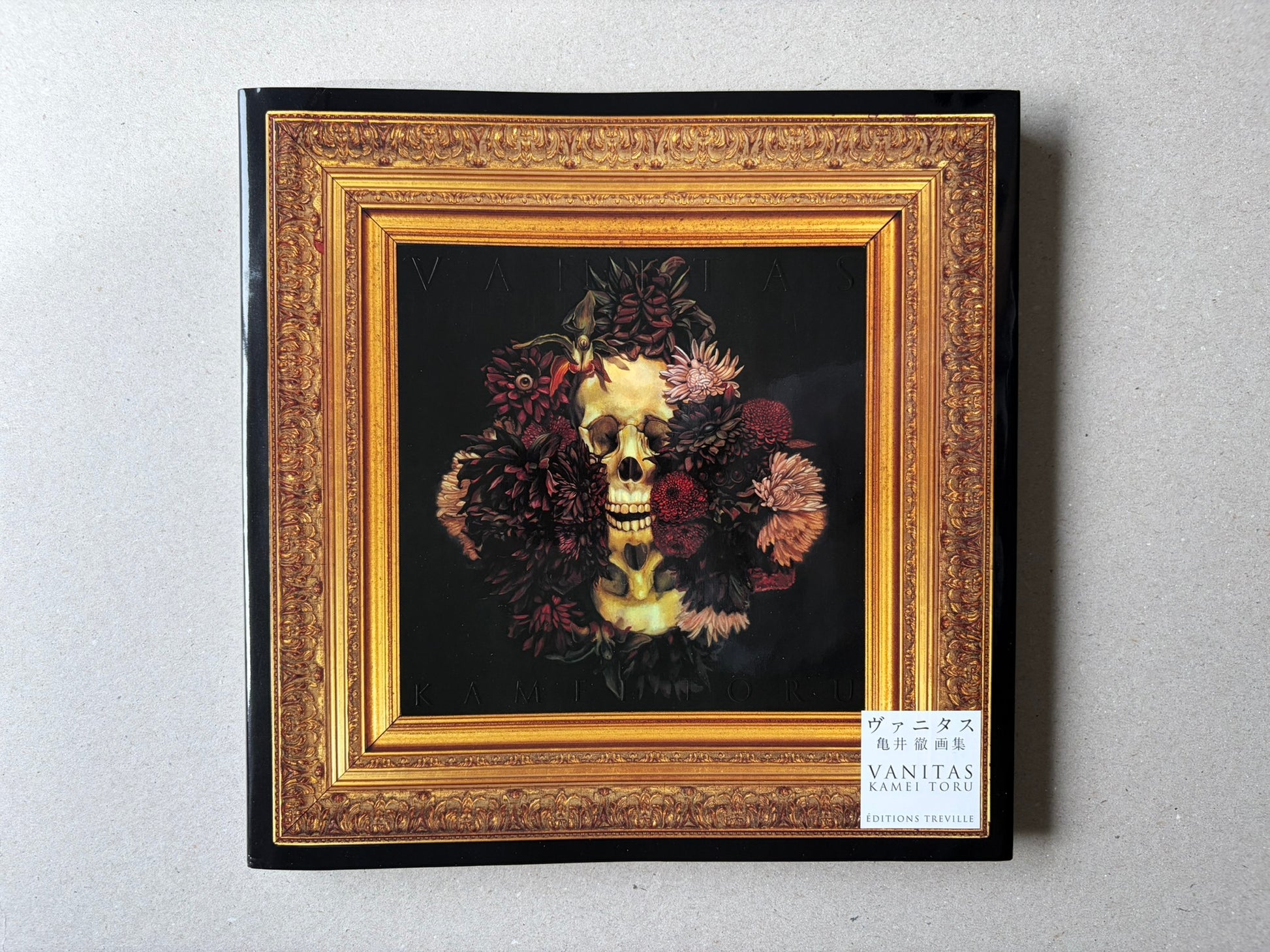 VANITAS by Toru Kamei, front cover with a framed skull and flowers on a black background, Editions Treville label at lower right.