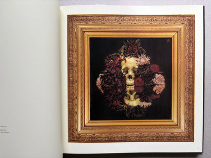 Open spread from VANITAS showing a framed floral animal portrait on the right page.