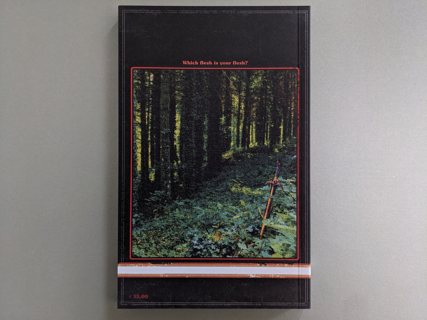 Back cover with a mossy forest, a glowing sword stuck in the ground, and the caption Which flesh is your flesh?