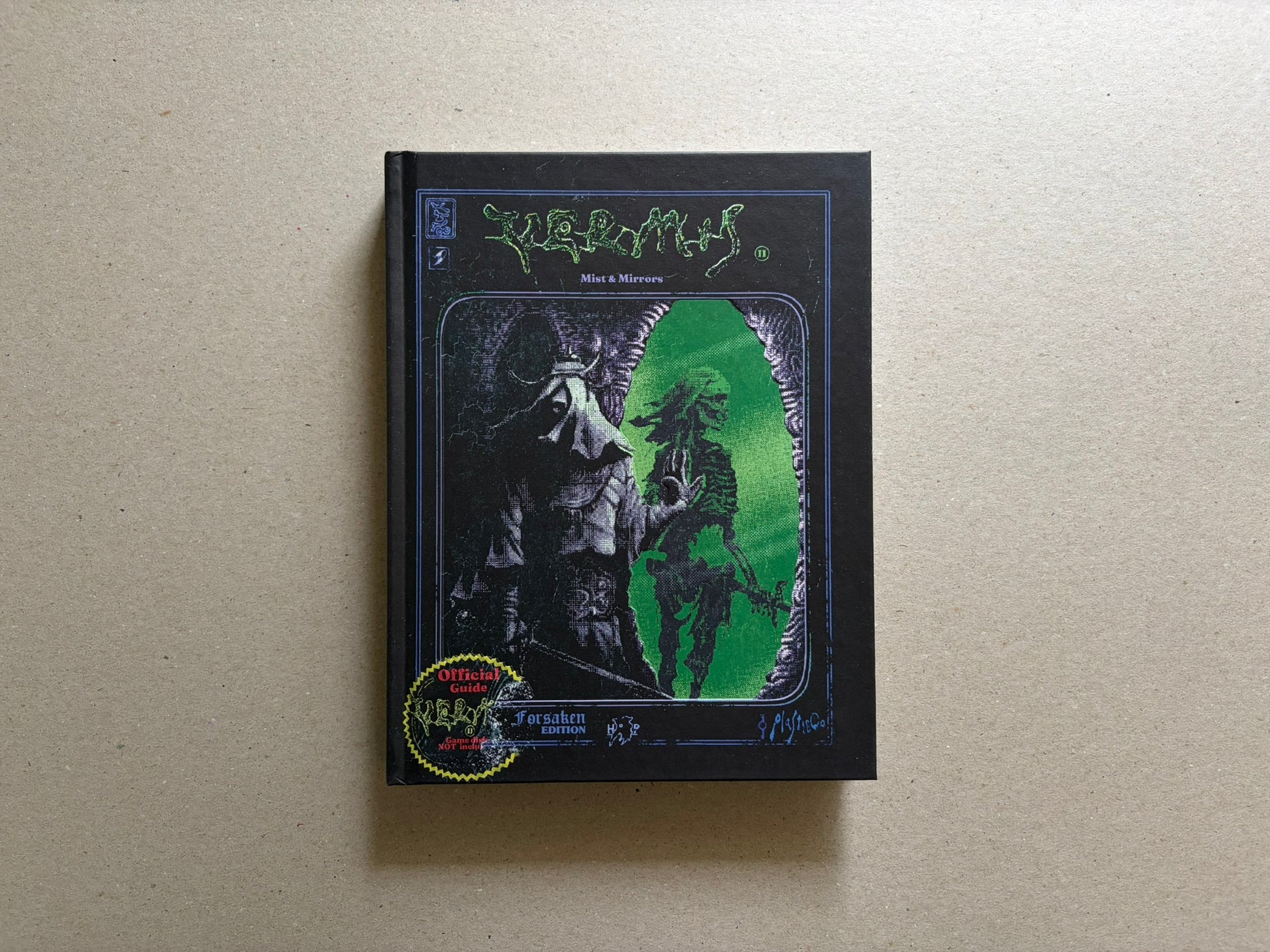 Vermis II – Mist & Mirrors (Forsaken Edition) hardcover front cover on a black background, with green title lettering and a central figure framed by a bright green portal.