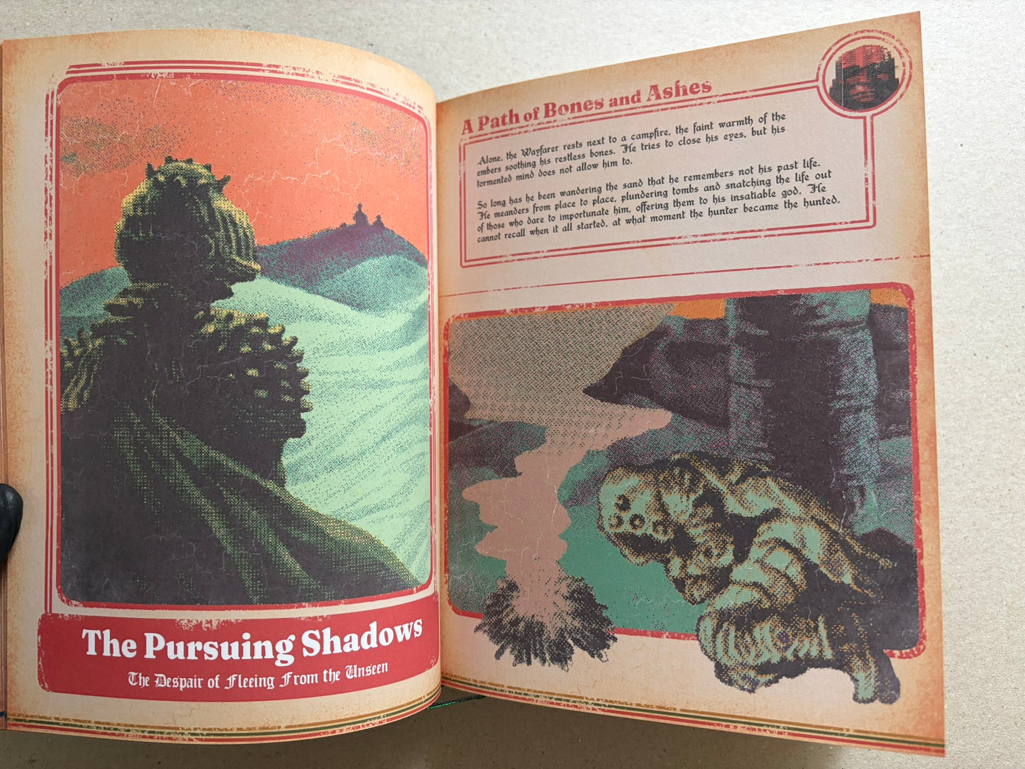 Open spread titled 'A Path of Bones and Ashes', with a large landscape illustration on the left and a text panel above a smaller scene on the right.