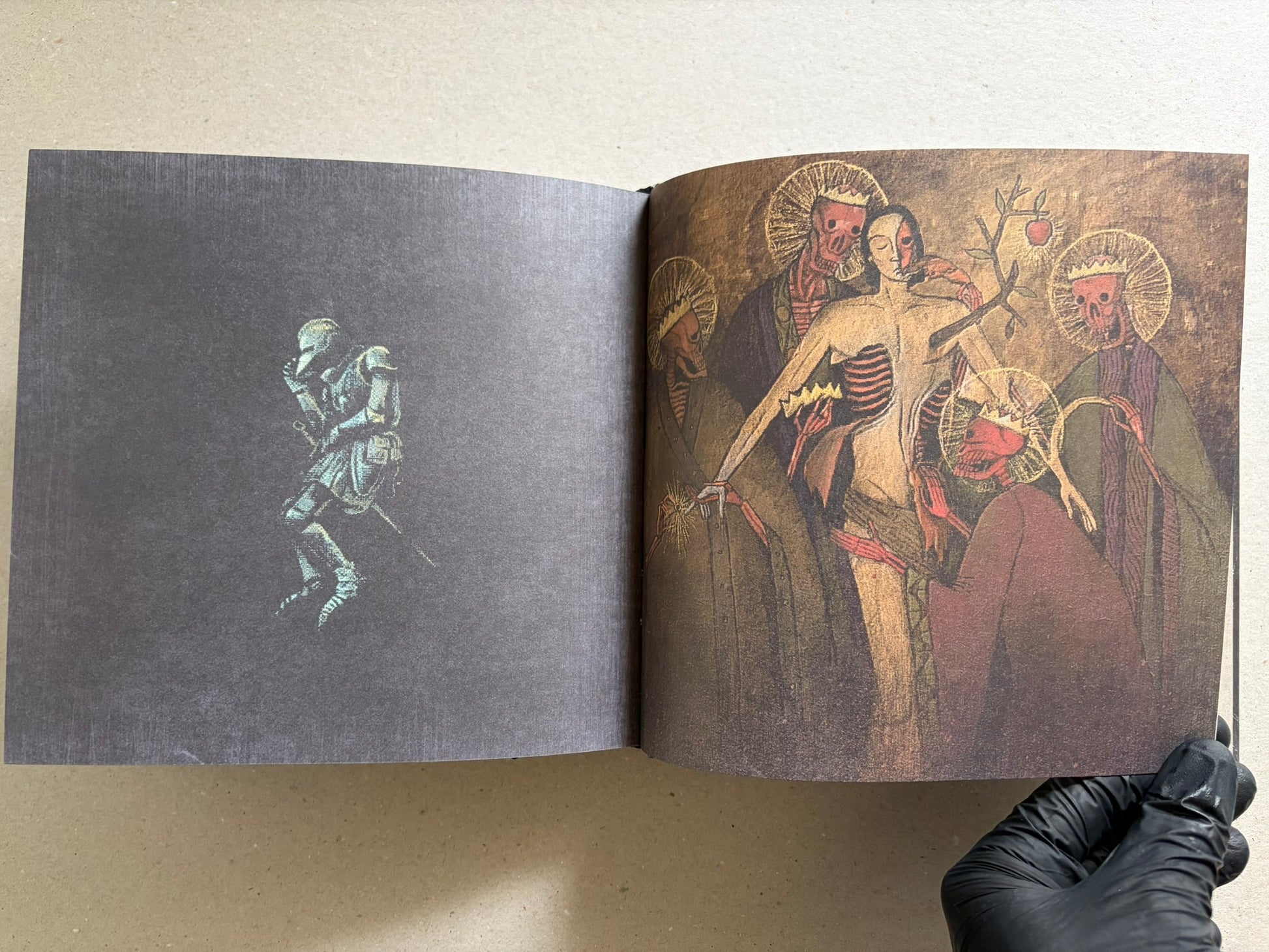 Open Vermis III Forsaken Edition spread with a small figure on the left page and a group of robed figures on the right.