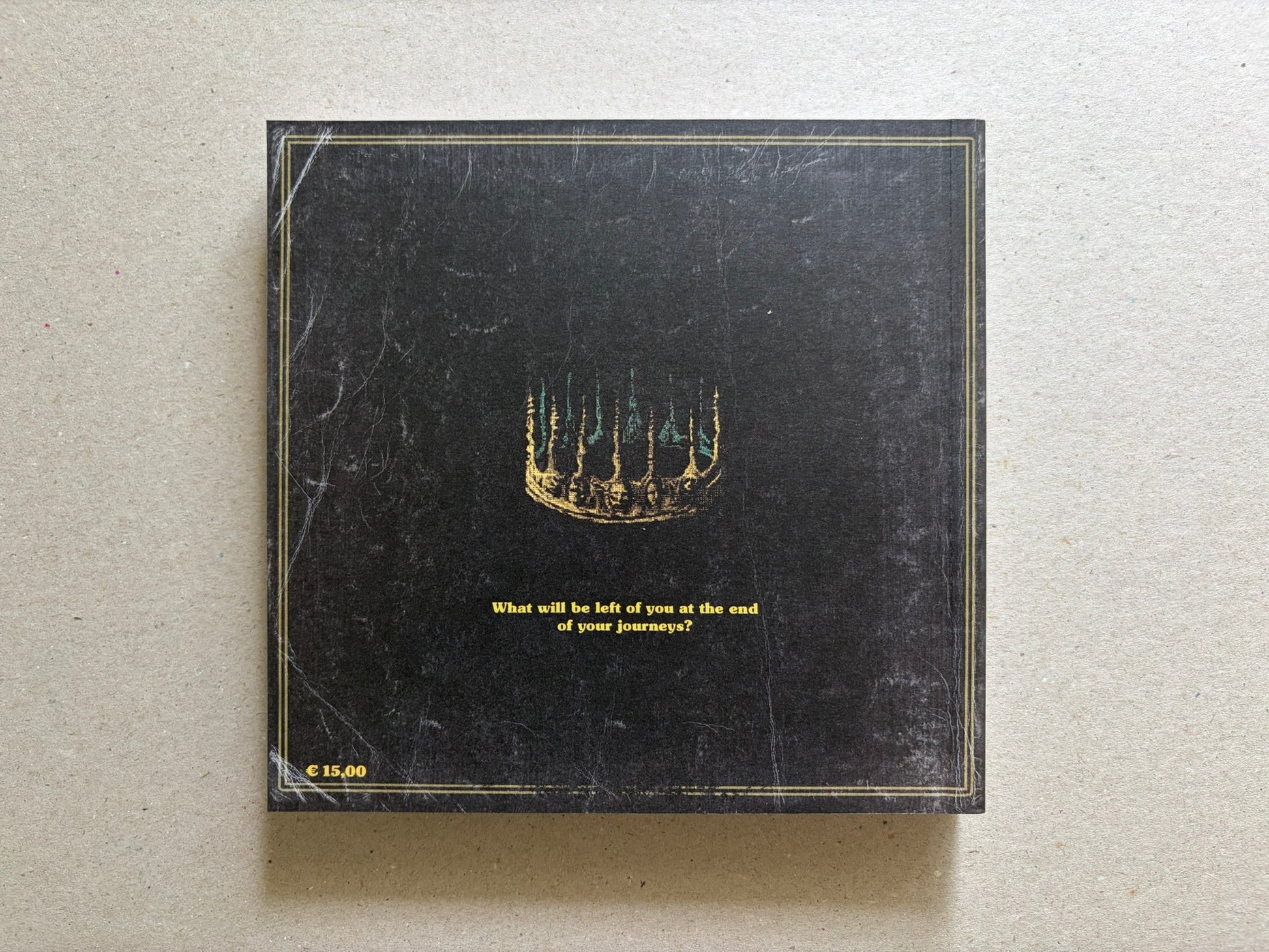 Vermis III back cover on a light tabletop, showing the black rear cover with the centered question and price mark.