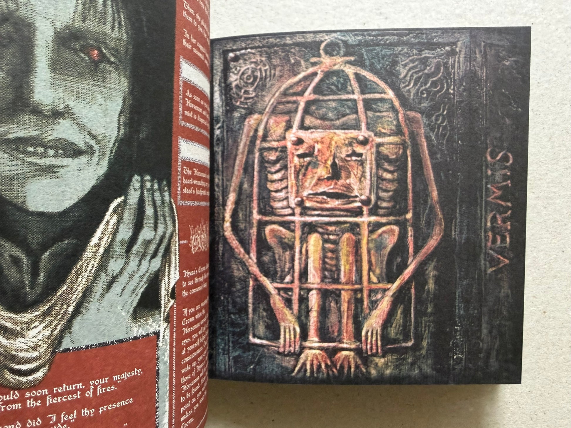 Open Vermis III spread with a close-up face on the left page and a caged figure illustration on the right page.