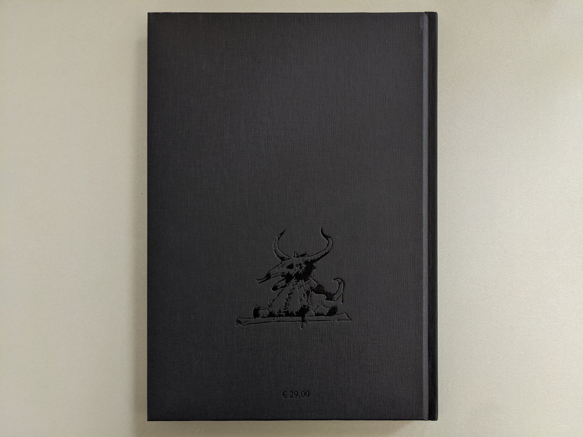 Back cover of 'Voodoo Forest' by John Blanche, showing a black clothbound texture with embossed demonic creature