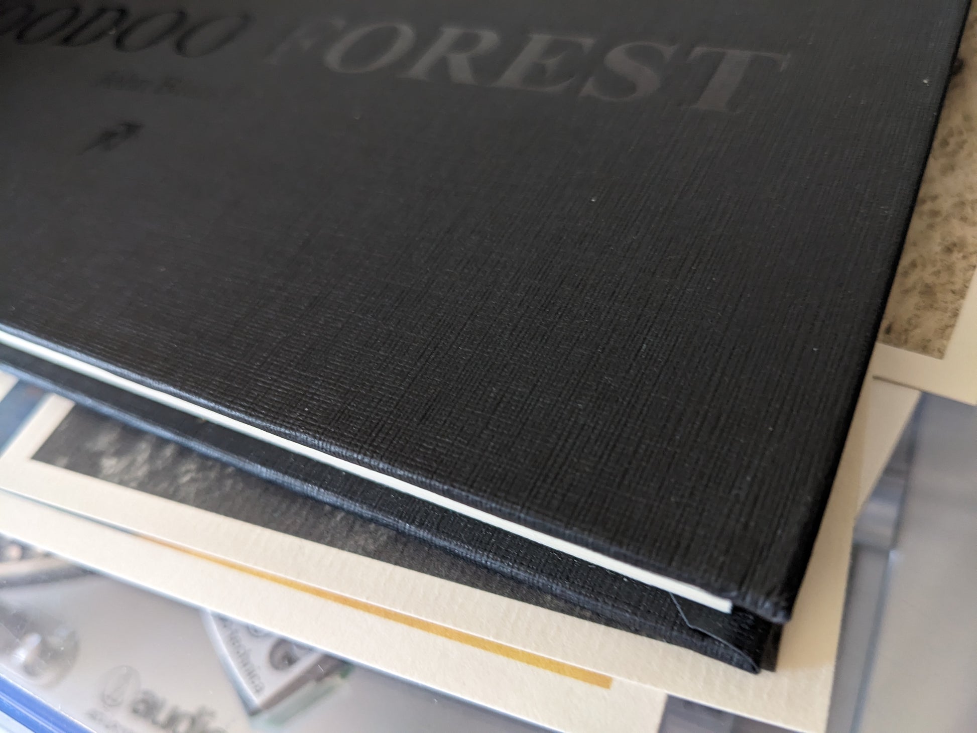 Damaged lower corner of Voodoo Forest book cover, showing slight bend in cloth binding