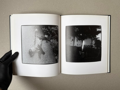 Open spread of Walk while ye have the light by Yoshiichi Hara, showing two black-and-white photographs on facing pages.