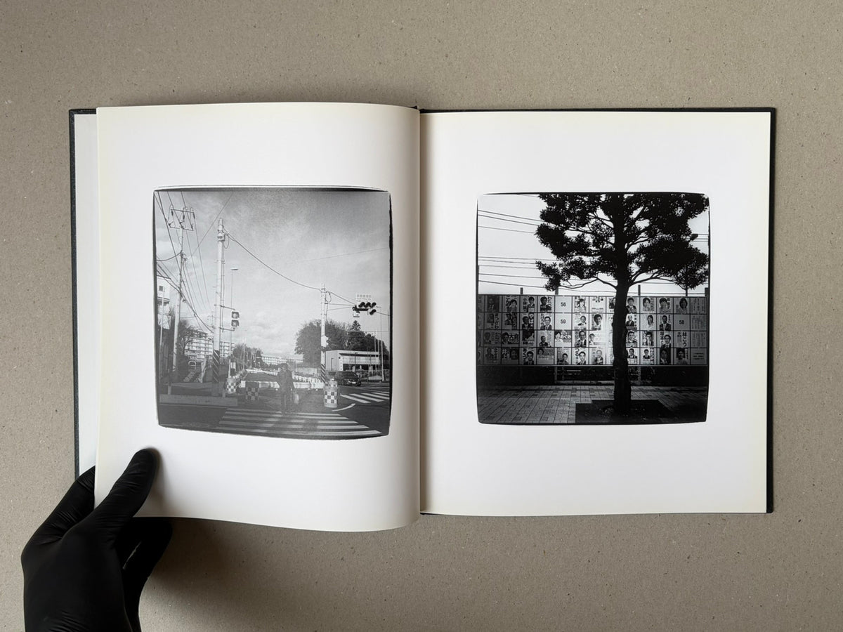 Open spread of Walk while ye have the light by Yoshiichi Hara, showing two black-and-white photographs on facing pages.