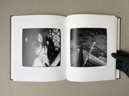 Open spread of Walk while ye have the light by Yoshiichi Hara, showing two black-and-white photographs on facing pages.